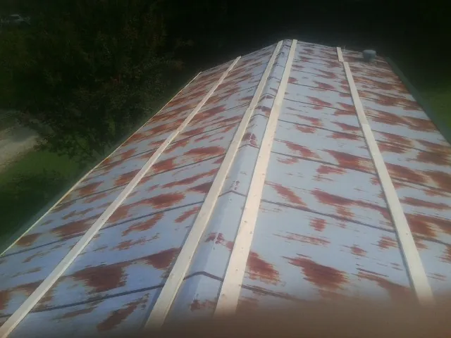 Rusted metal roof panels with new wood purlins before replacement — Storm Damage Roof Repair in Timmonsville by Roofing Brothers