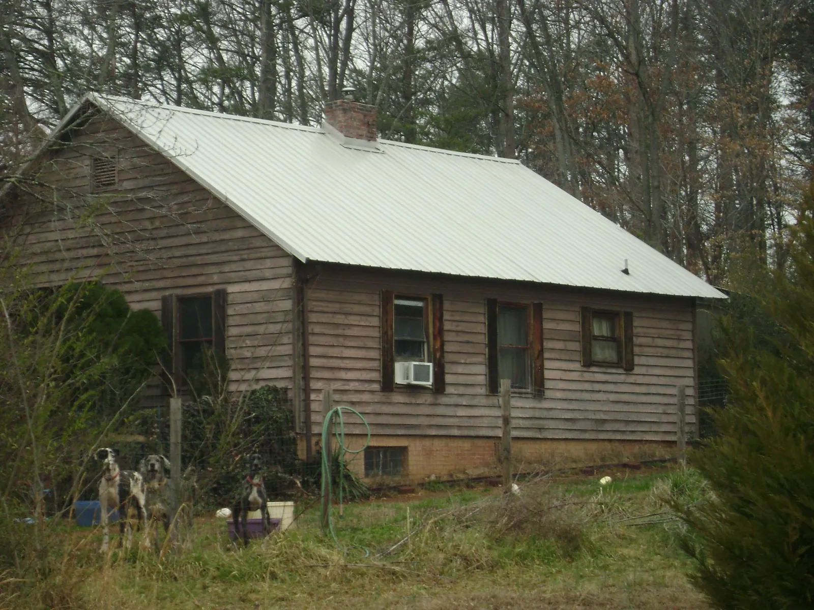 White metal roof on an old wood sided farmhouse, from a Metal Roof Installation job in Timmonsville